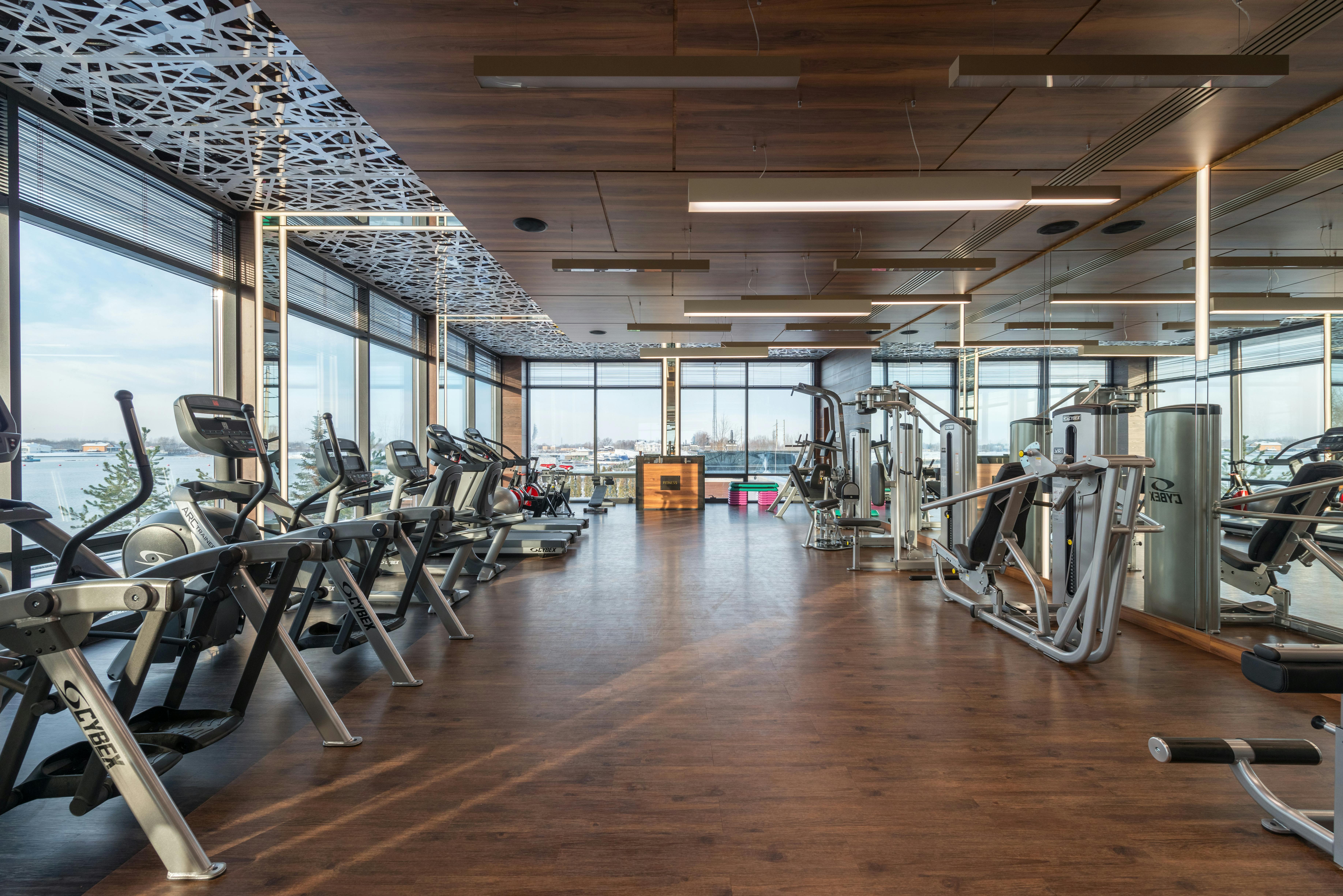 FitCore Gym main workout floor showing modern equipment, mirrors, and natural lighting